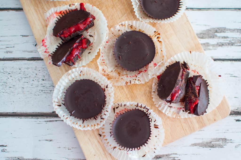 Clean eating dark chocolate cups recipe with gorgeous strawberry sauce filling. Indulging and healthy with zero guilt feelings afterwards #vegan #rawchocolate #healthy #cleaneating #glutenfree #dairyfree