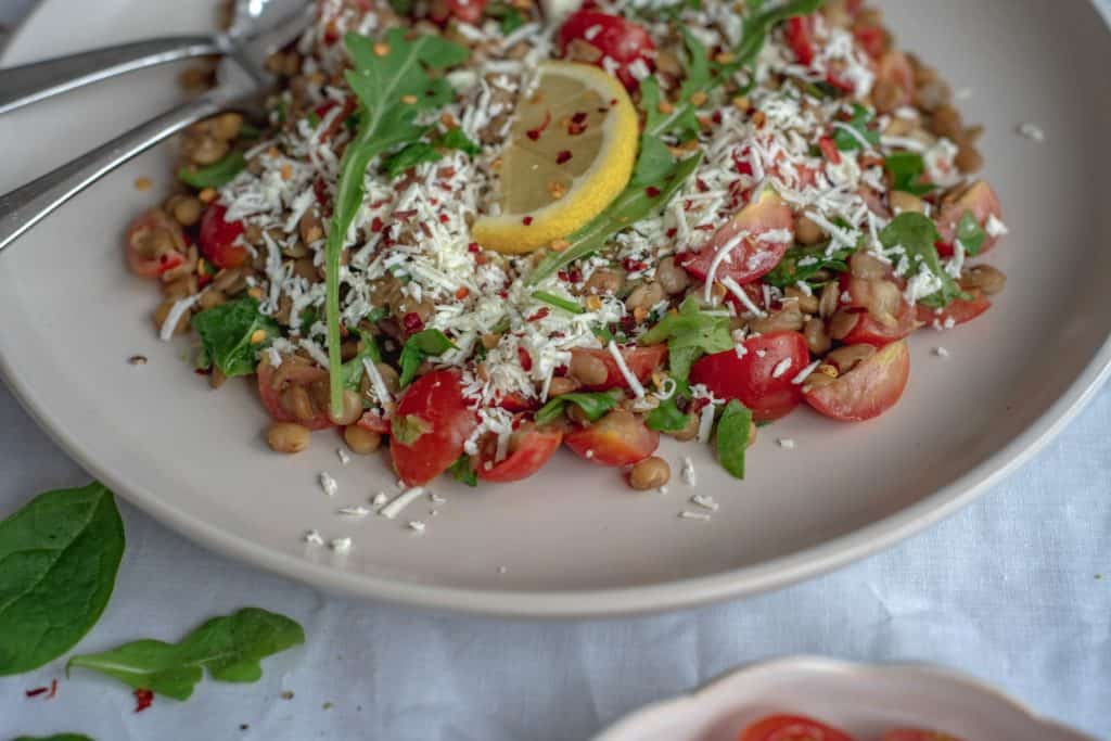 Healthy and easy lentil salad recipe with sweet cherry tomatoes, spinach, dairy free feta cheese all drizzled with a maple mustard dressing. Simply delicious!