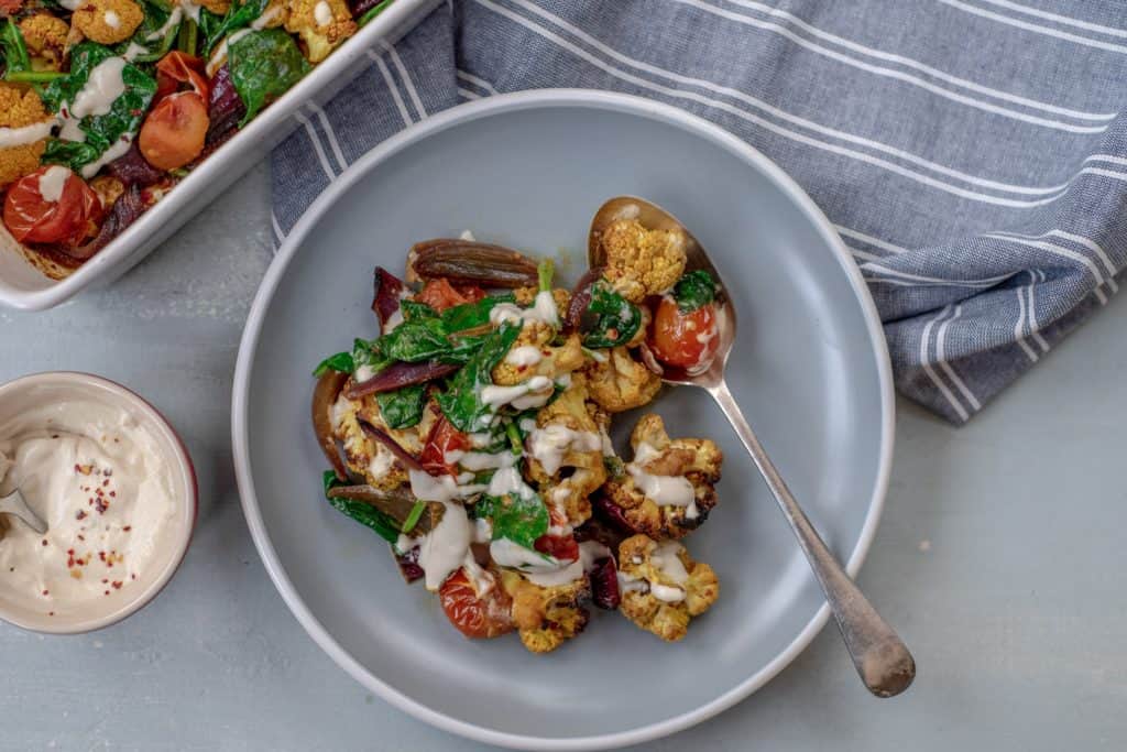 Absolutely delicious one-pot healthy cauliflower bake recipe served with lush tahini and yoghurt dressing. Super-satisfying while vegan, gluten & grain free!#veganrecipes #glutenfree #dairyfree #cauliflowerbake #healthyrecipes #cleanrecipes #cleaneating #easyrecipes 