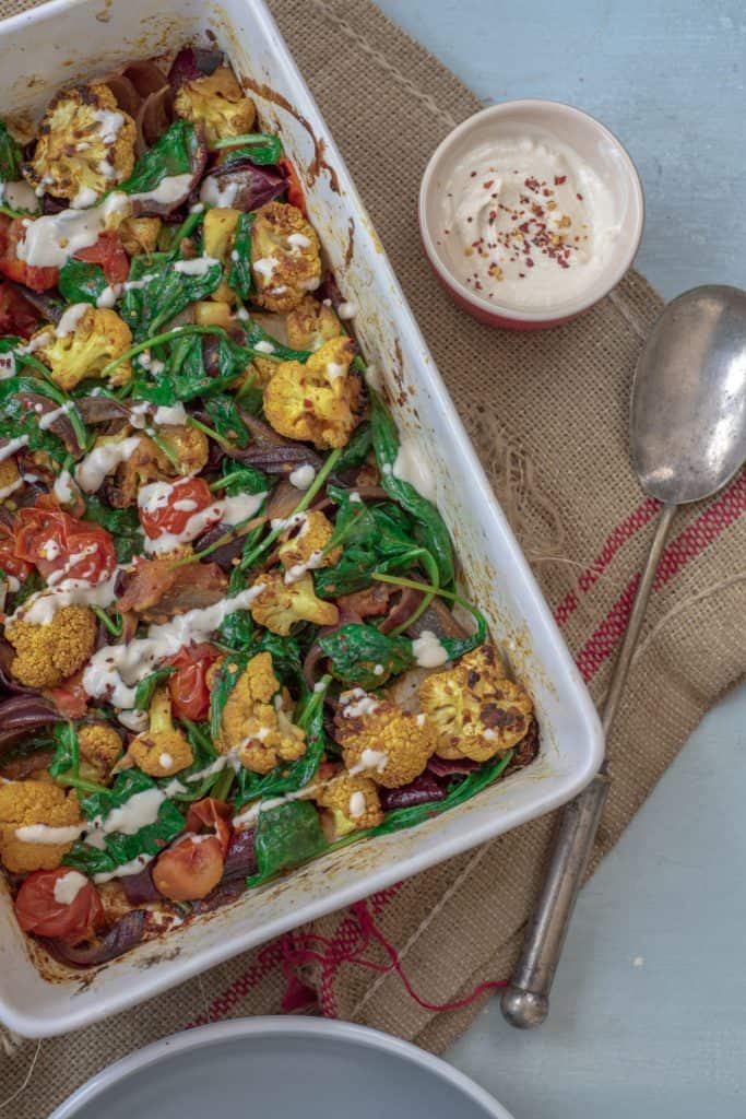 Absolutely delicious one-pot healthy cauliflower bake recipe served with lush tahini and yoghurt dressing. Super-satisfying while vegan, gluten & grain free!#veganrecipes #glutenfree #dairyfree #cauliflowerbake #healthyrecipes #cleanrecipes #cleaneating #easyrecipes 
