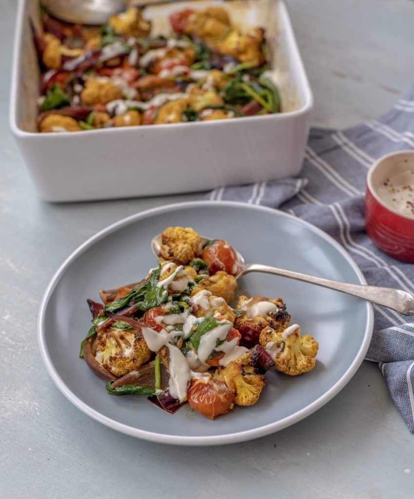 Absolutely delicious one-pot healthy cauliflower bake recipe served with lush tahini and yoghurt dressing. Super-satisfying while vegan, gluten & grain free!#veganrecipes #glutenfree #dairyfree #cauliflowerbake #healthyrecipes #cleanrecipes #cleaneating #easyrecipes 