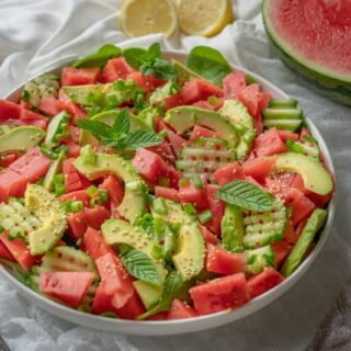 Delicious, quick and healthy watermelon salad with spinach, avocado, cucumber, spring onions and sesame seeds. Serve with freshly squeezed lemon juice! #easymeals #vegansalads #summerrecipes # eatwell #quickrecipes #homemade