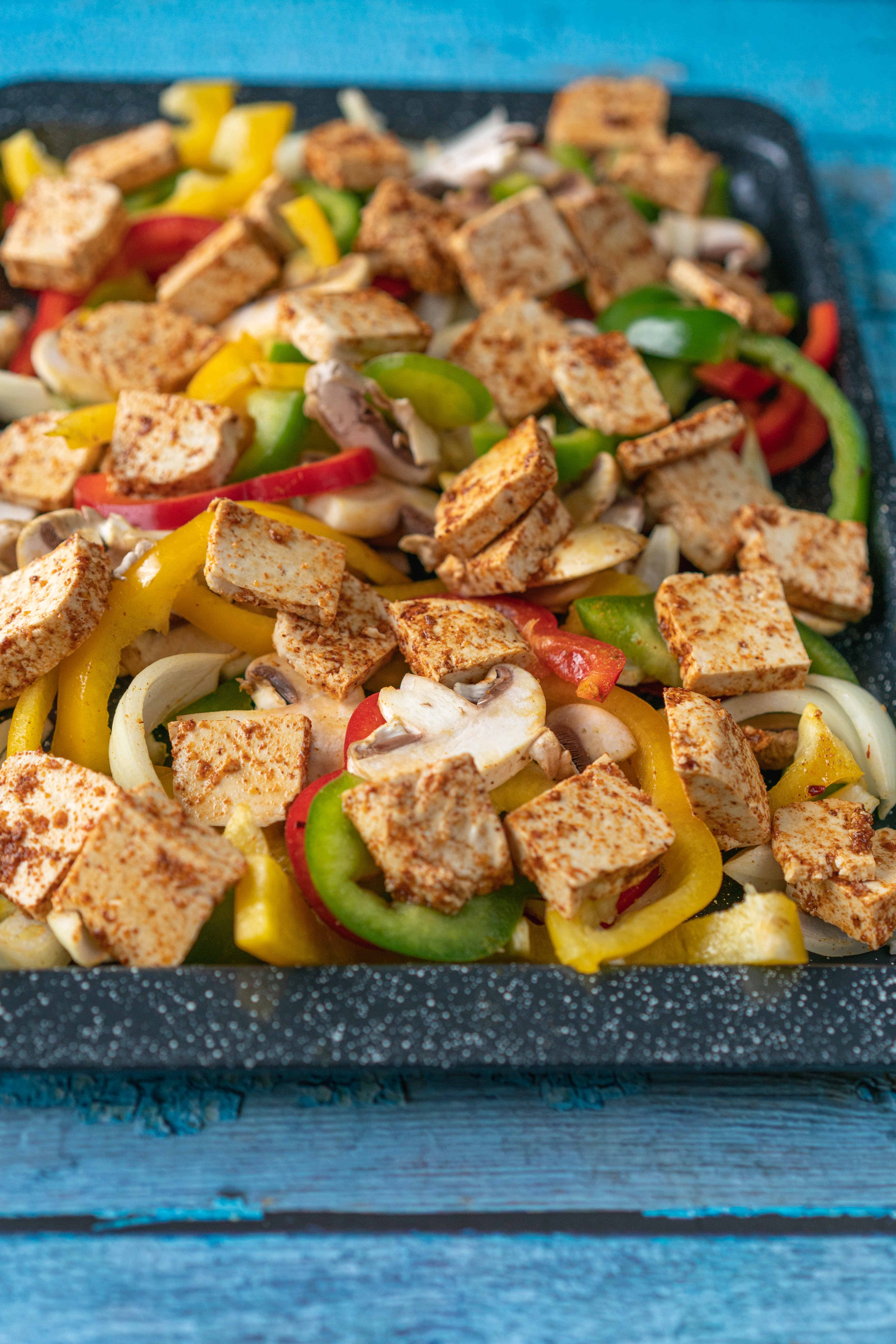 An easy and healthy tofu traybake with vegetables baked to perfection that will have you craving more! Vegan & Ready in 30 Mins.